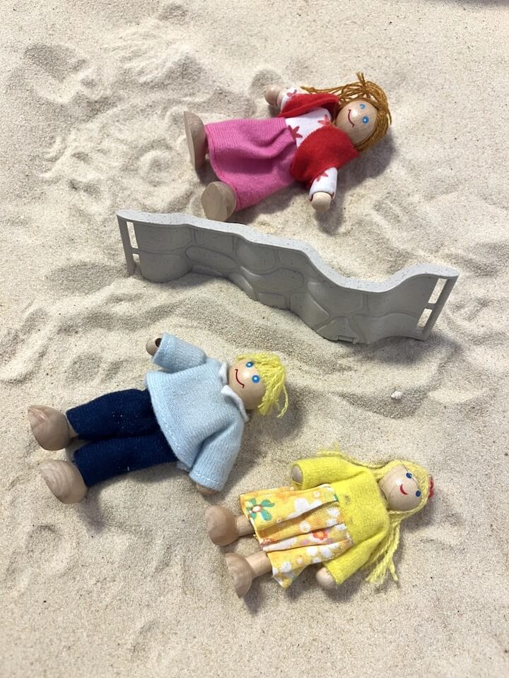 Dolls in a sand pit for play